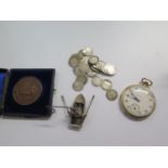 A rolled gold dress pocket watch retailed by Grosvenor, together with a monocle, a silver figurine,