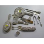 A lady's toilet collection consisting of a silver hand mirror, brush and comb, silver topped glass