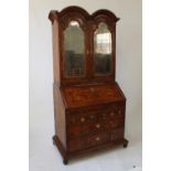 A Fine Queen Anne Double Domed, Oyster Veneered Burr Walnut Mirrored Bureau Bookcase. Circa 1705.