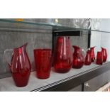 A Whitefriars-style red glass ovoid vase 30cm, tapering cylindrical vase 21cm and six jugs with
