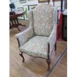 An Upholstered Mahogany framed Wing Arm Chair. On cabriole legs.