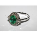 18ct white gold oval emerald and diamond cluster ring. Emerald 1.41ct. Diamonds 0.82ct.