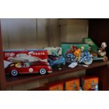 Tinplate toys: Flip-over Training Plane, Sports Car, Drumming Panda and motorcycle in original boxes