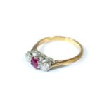 An 18 carat gold diamond and ruby three stone ring, size N
