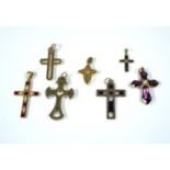 A collection of seven gold crosses gem set with enamel decoration to on, colour stones to others (