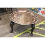 An Egyptian Copper and hardwood table. Stamped BBB. 39cm x 74cm diameter