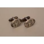 A pair of silver cufflinks