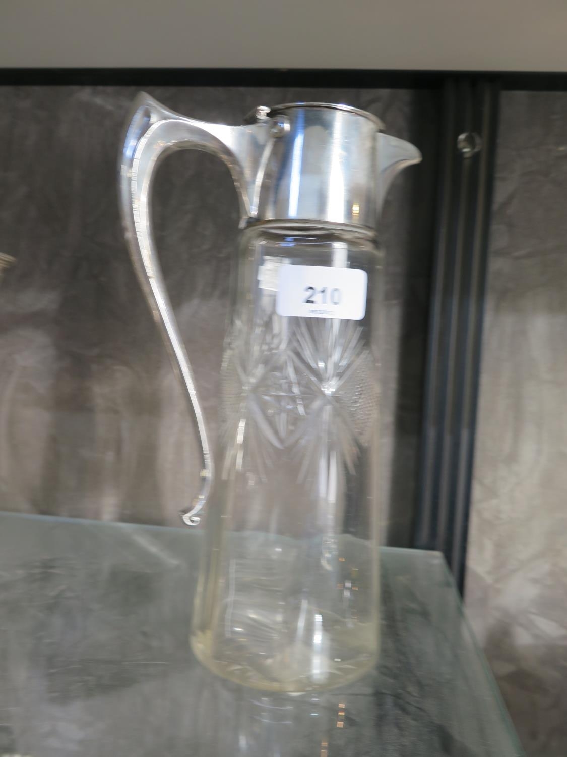 A cut glass and silver plate lidded claret jug 25cm