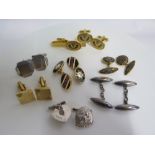A collection of seven pairs of cufflinks, some silver and a tie pin
