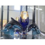 Two Poole dolphins and a blue and gilt glass vase 27cm (2)
