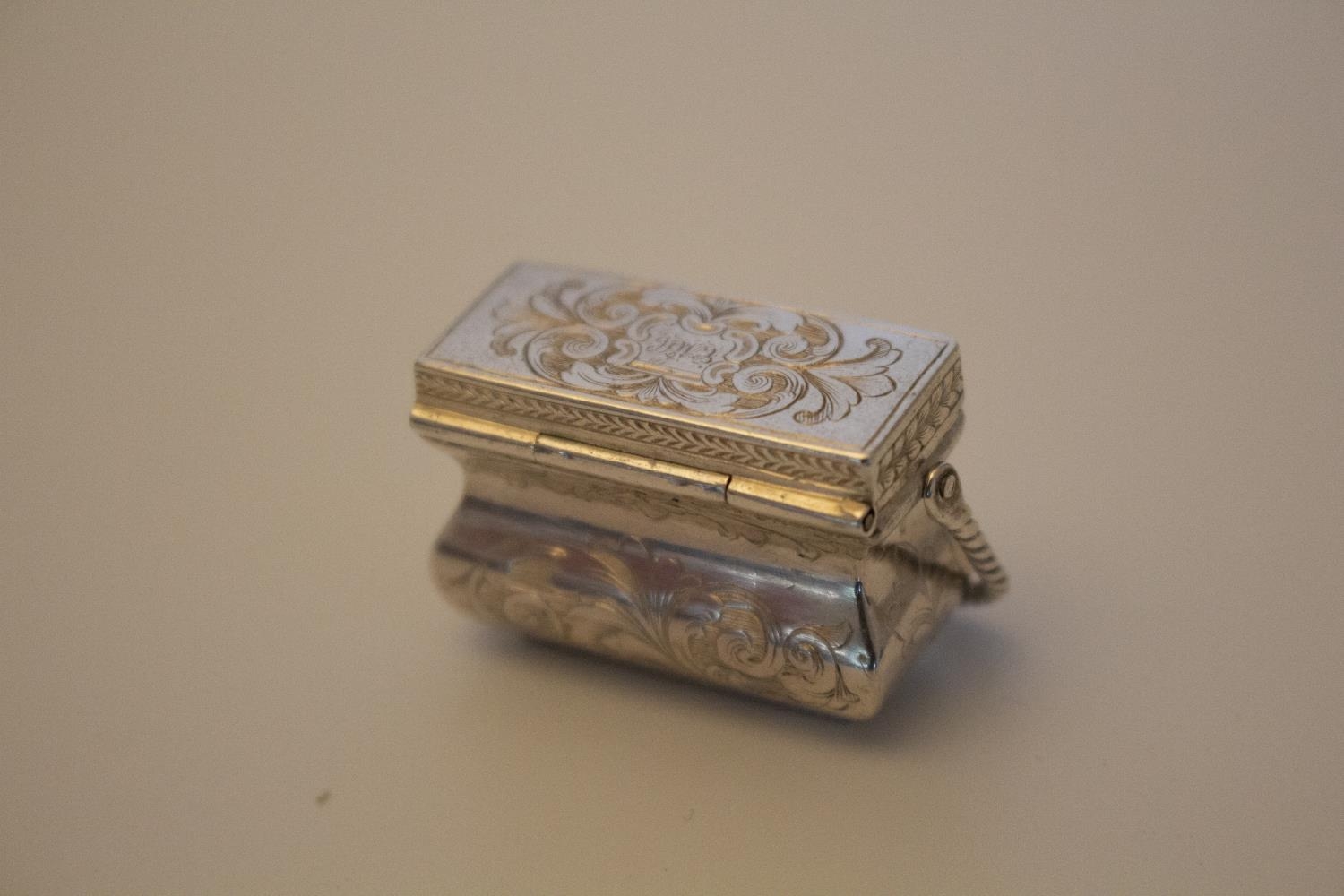 A Mid Victorian Sterling Silver Vinaigrette. In the form of a purse with swing handle. Makers mark