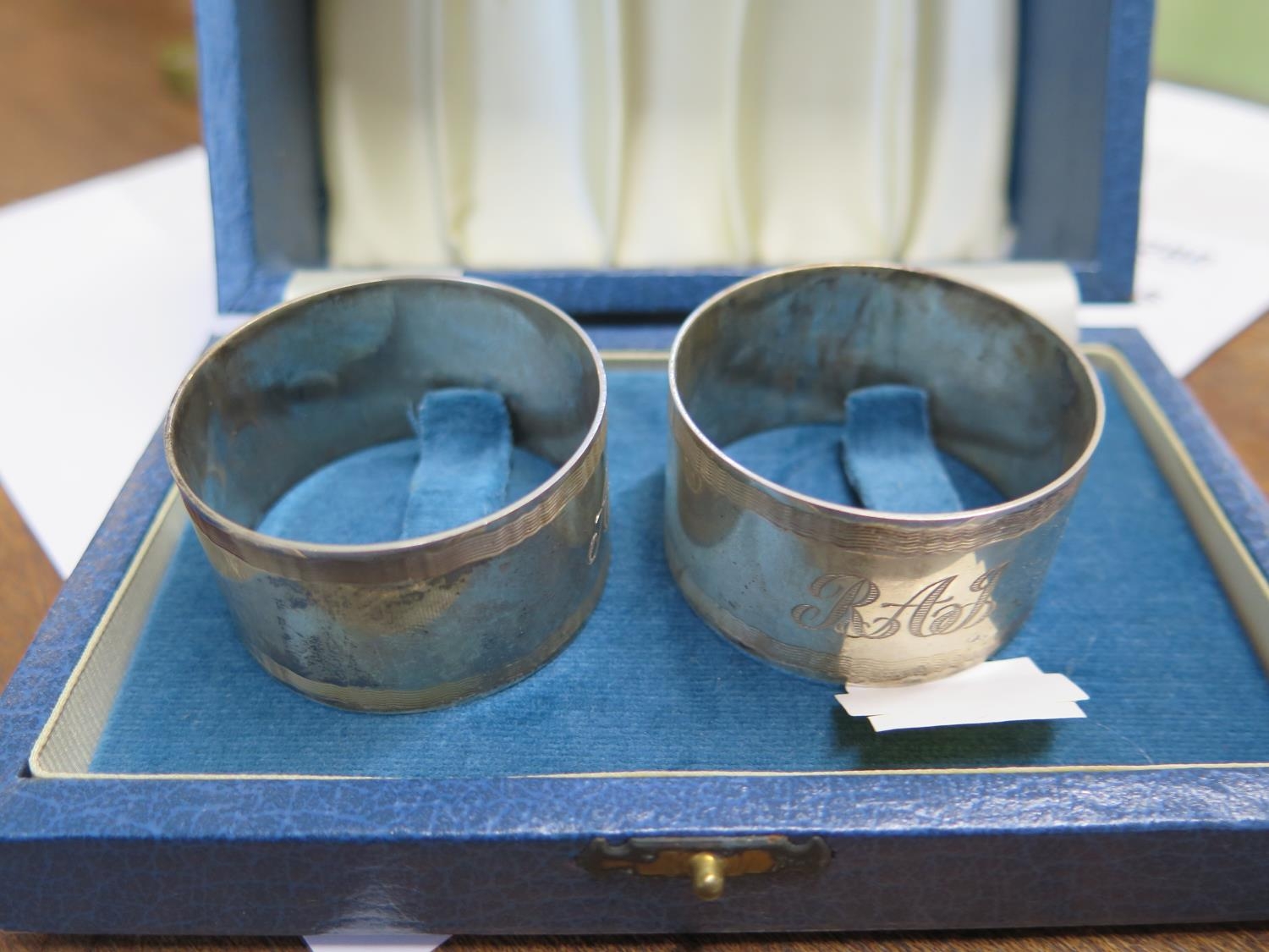 A Pair of Queen Elizabeth II Napkin Rings. Birmingham 1985. With fitted case. Each 4.5cm diameter.62