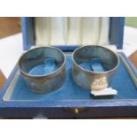 A Pair of Queen Elizabeth II Napkin Rings. Birmingham 1985. With fitted case. Each 4.5cm diameter.62