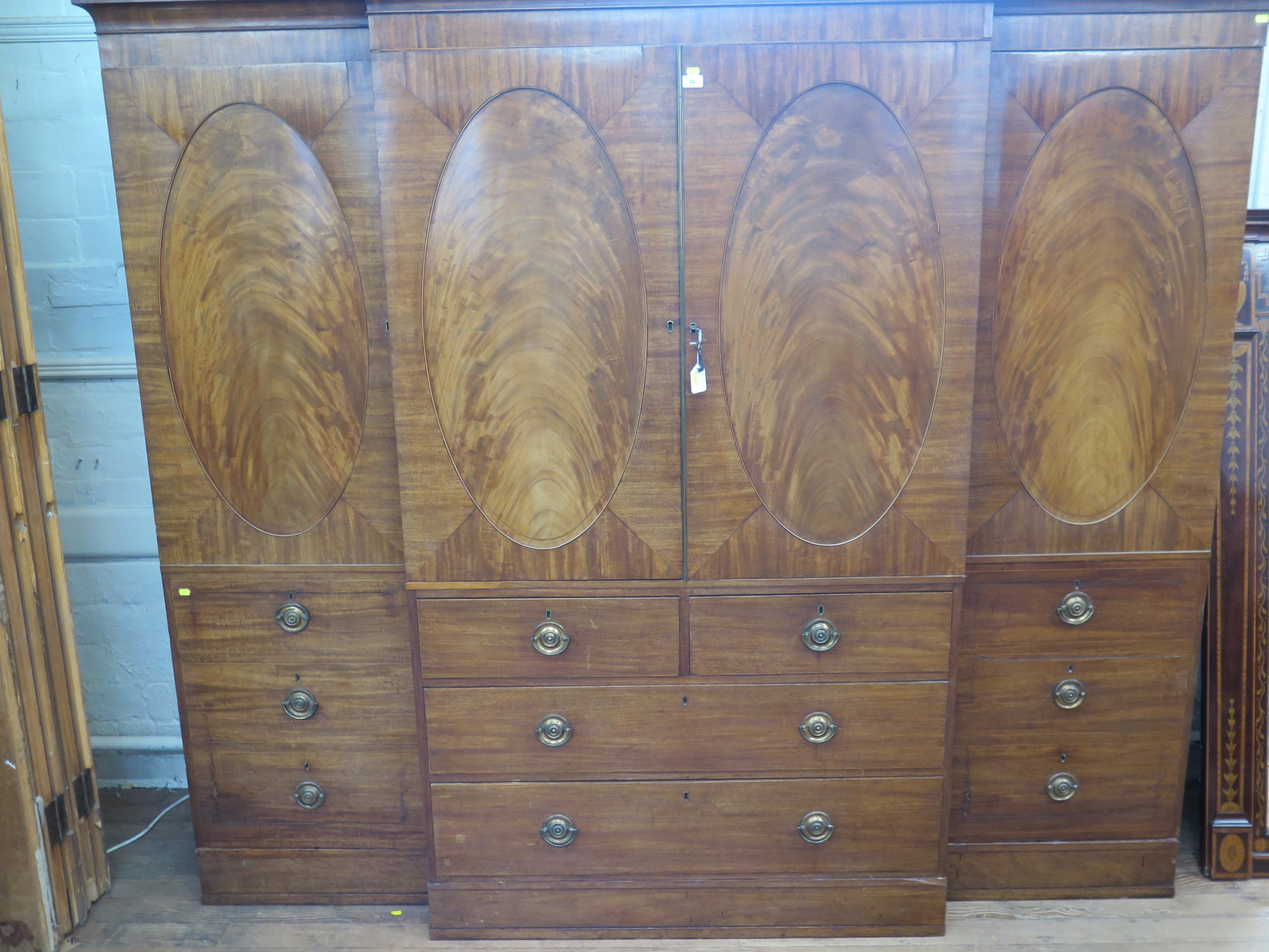 An Impressive George III Mahogany Break Front Wardrobe. Circa 1800. The central doors flanked by