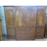 An Impressive George III Mahogany Break Front Wardrobe. Circa 1800. The central doors flanked by