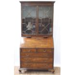 A George III Mahogany Bureau Bookcase. Circa 1770. The upper portion with a stepped cornice above