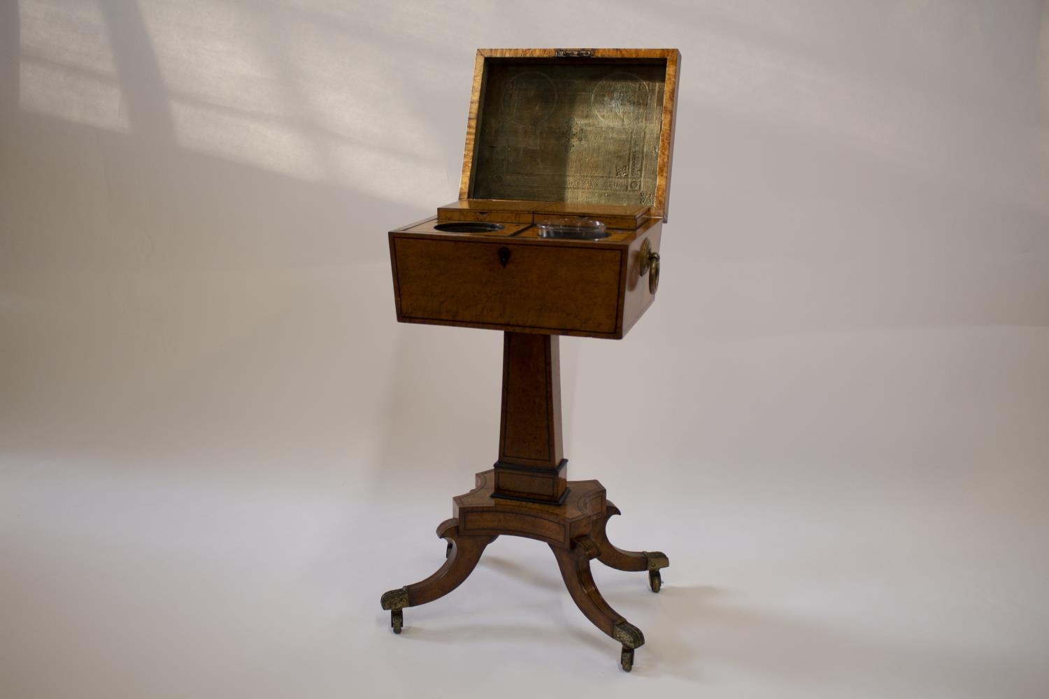 A Fine George III Birds Eye Maple Teapoy. The hinged cover opening to reveal two lidded compartments