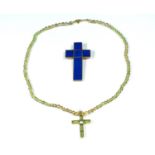 A 9 carat gold cross set with lapis lazuli and a peridot beaded necklace