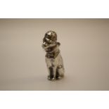 A Modern Cast Sterling Silver Pepperette. In the form of a seated dog. Realistically modelled.