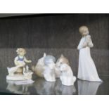 Four Lladro Nao figures including cat with wool ball and one other figure of figure of girl with