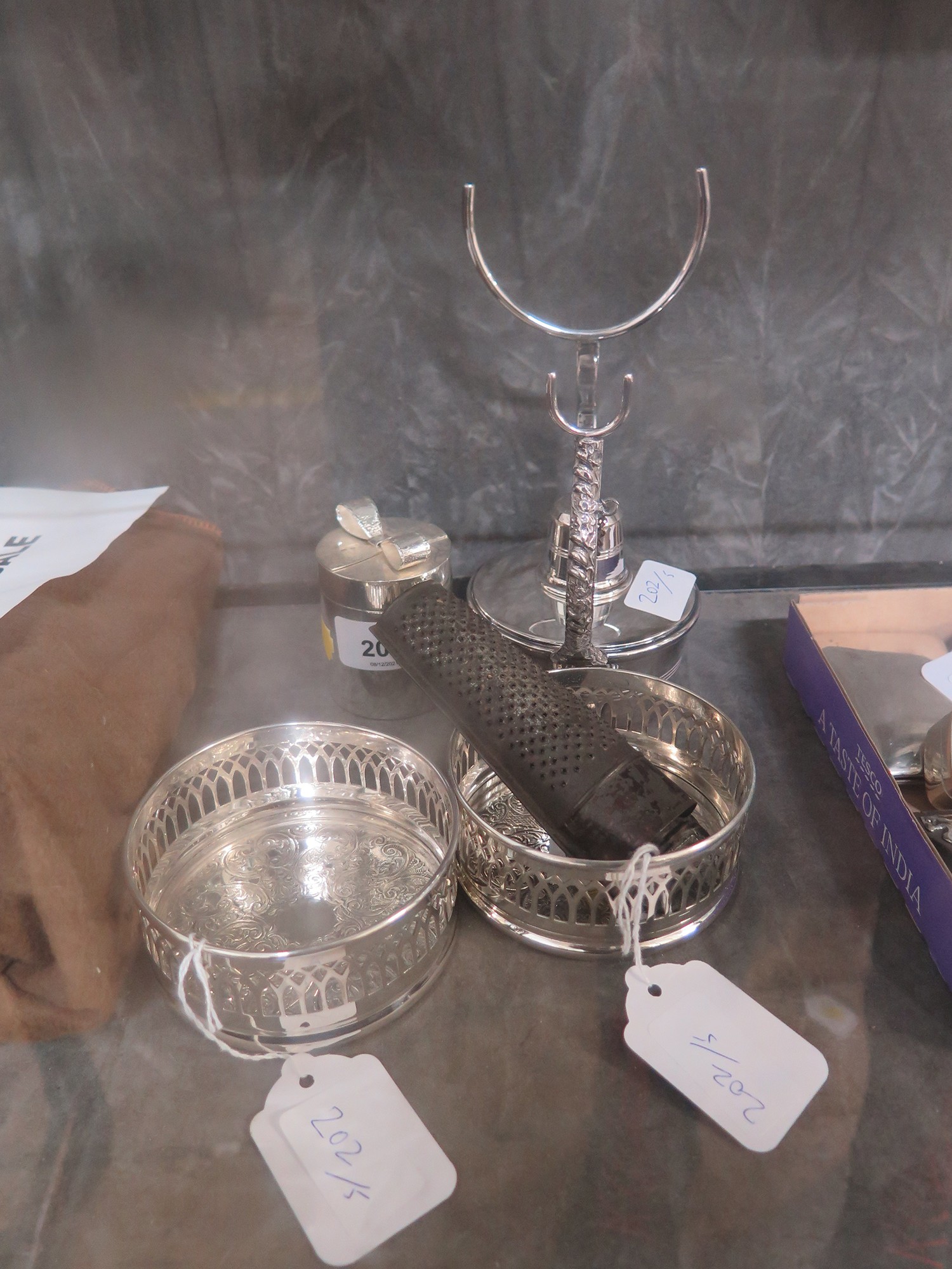 A pair of silver-plated wine coasters, Brandy warmer, rasp and a cylindrical box (5)