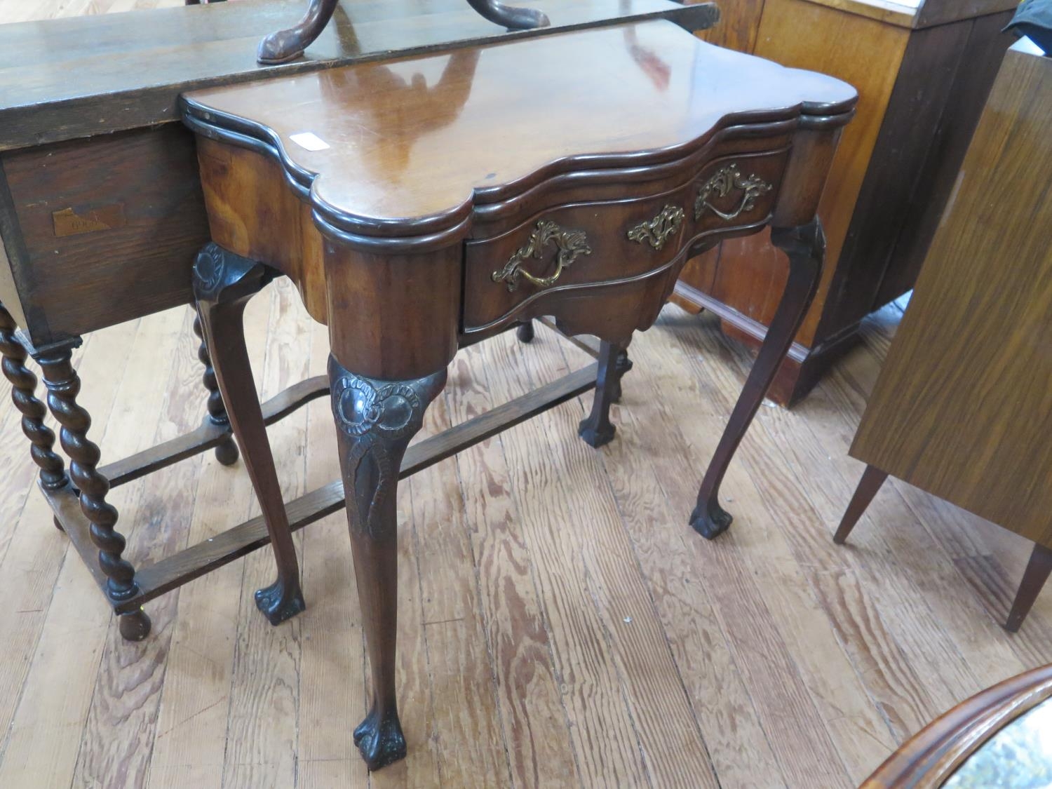 A Good Late George II Red Walnut Tea table. Circa 1750. The shaped top opening to reveal a