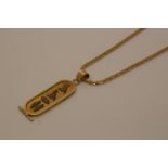 An 18 carat gold neck chain, 12g, with a gold coloured metal Egyptian panel pendant