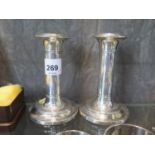 A small pair of straight sided silver candle sticks, some 4" tall