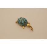 An 18 carat gold charm in the form of a tortoise set with turquoise 4.8g and a 14 carat gold neck