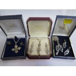 A collection of five sets of silver jewellery, some gem set, cased, each set has a necklace or penda