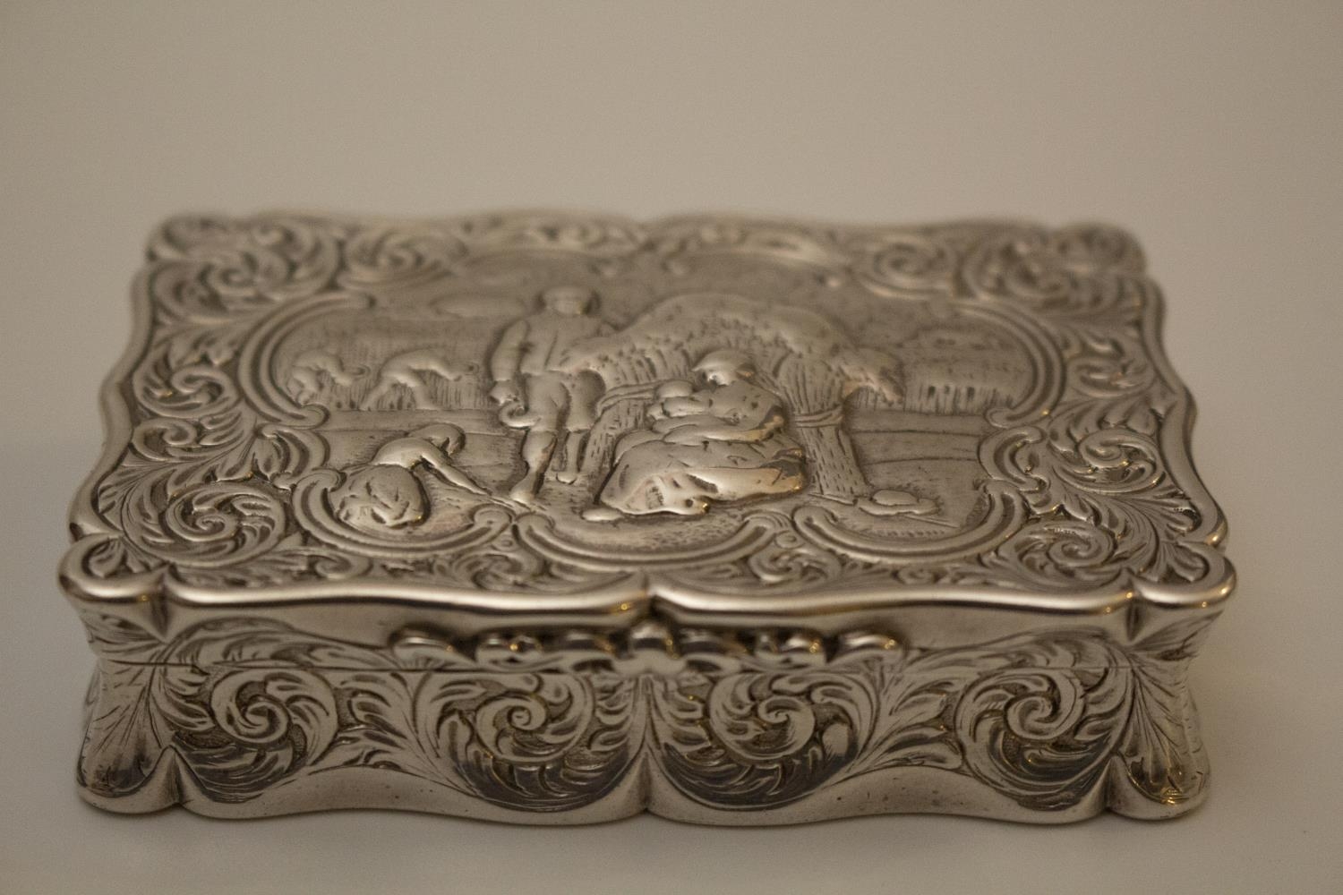 A George IV Sterling Silver Table Snuff Box. Edward Smith. Birmingham 1829. Embossed with figures in