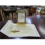 A carriage clock. In a Corniche case. Together with a key and a guarantee from Garrards