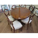 A Fine Victorian Walnut Oval Dining Table. Circa 1850. Together with six balloon back dining chairs.