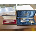 A silver pen and pencil set and a silver knife, fork and spoon set, both cased