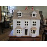 A modern wood dolls house, opening front and roof 62cm x 62cm, the four rooms with assorted