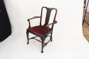 A Fine Irish Mahogany Arm Chair. Cira 1740. The splat carved with foliate scrolls on matted