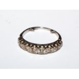 A half eternity ring set with diamonds, size H