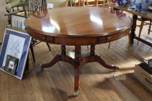 A modern Mahogany veneered centre table. In 19th century style. The circular top fitted with four