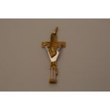 An 18 carat gold and silver pendant depicting Jesus on the cross