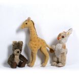 AN EARLY 20TH CENTURY STUFFED TOY GIRAFFE in the manner of Steiff, 34cm in height together with