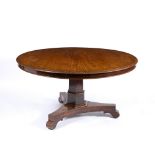 A VICTORIAN MAHOGANY CIRCULAR TILT TOP BREAKFAST TABLE with a hexagonal stem and triform base, 135cm