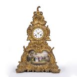 A GILT SPELTER AND GESSO CONTINENTAL MANTLE CLOCK set with a porcelain panel decorated with a