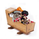 A PINE CHILD'S ROCKING CRIB 85cm x 32cm together with a stuffed Paddington Bear and further dolls