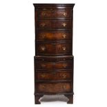 A GEORGIAN STYLE MAHOGANY VENEERED SERPENTINE FRONTED SMALL SIZE CHEST ON CHEST with six drawers and