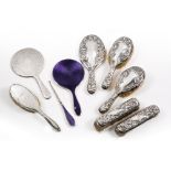 AN EARLY 20TH CENTURY ART NOUVEAU SILVER BACKED DRESSING SET to include four brushes and a mirror, a