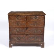 AN 18TH CENTURY AND LATER OAK CHEST OF TWO SHORT AND THREE LONG DRAWERS with chip carved decoration,