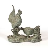 A BRONZE SCULPTURE depicting a cockerel and a chicken, 36cm wide x 36cm high Condition: the cockerel