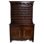 A CONTINENTAL FRUITWOOD SIDE CABINET with twin drawers over cupboard doors and standing on scrolling