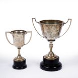 A SILVER TROPHY CUP 17cm high together with a further smaller silver trophy cup with worn marks,