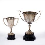A SILVER TROPHY CUP 17cm high together with a further smaller silver trophy cup with worn marks,